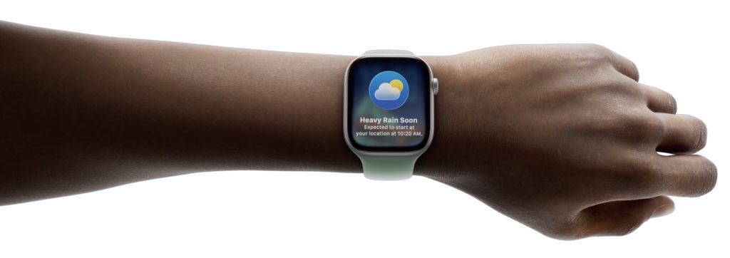 wrist with Apple Watch showing watchOS 26